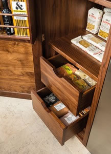 Walnut interiors and solid oak drawers are a regular feature in Tom Howley’s bespoke designs, so displaying these options in the Chelsea showroom was essential. To inspire and show clients the functionality of the different storage solutions available, each display has been dressed as if it were a real kitchen.