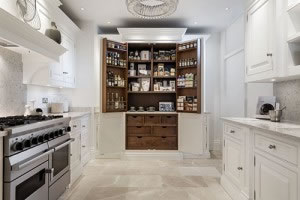 To the rear of the showroom is the new hand-painted Devine kitchen. This classic design is shown in the Sorrel colour finish, exclusive to Tom Howley, with dark oak veneer cabinetry and finished with polished nickel knobs.