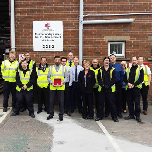 Pictured Raja Hussain (front) holding the Diamond Award with some staff members from the IDS Leeds site