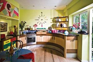 The single counter encourages a good flow. My brother Chris made the wall clock with kitchen utensils. Colours were inspired by a gypsy wagon
