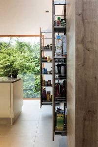 Pull-out storage helps keep the kitchen and worktops free from clutter