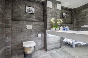 Seamless: Bauhaus Svelte platinum WC, European Tiles Revolve Black on walls and floor with bespoke Faeber basin