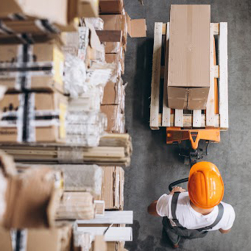 Young man working at a warehouse with boxes. Credit Freepik.com