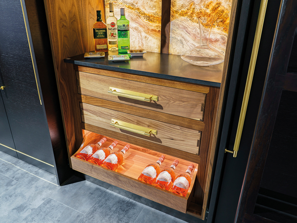 The BKNC hand-made solid wood and stained veneer home bar offers a stunning contrast to surrounding displays. It features Buster and Punch handles to give a contrasting, industrial aesthetic