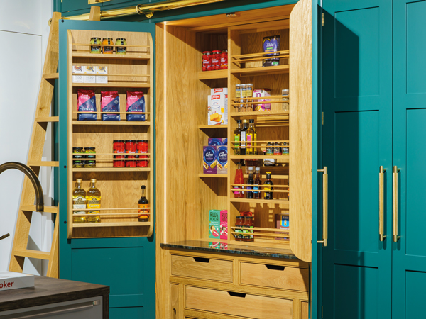 The pantry is hand-painted in a bold Farrow and Ball green, it is complemented with bespoke double bevelled framing, shaker doors with solid oak internals